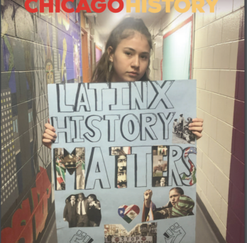 Student holding a poster reading 